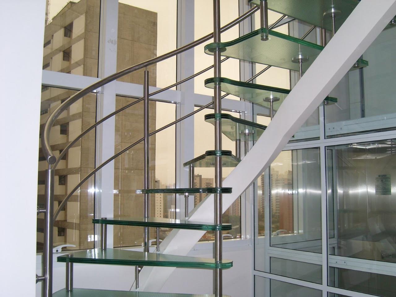 Escada caracol com estrutura aço inox e degraus vidro
